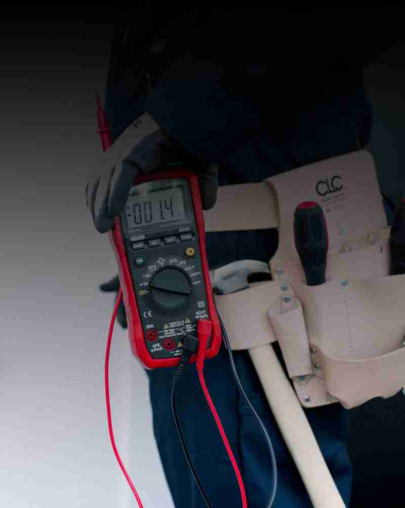 electrician_26 Sydney Security Systems being assessed by security technician wearing gloves using a multimeter and checking voltages.