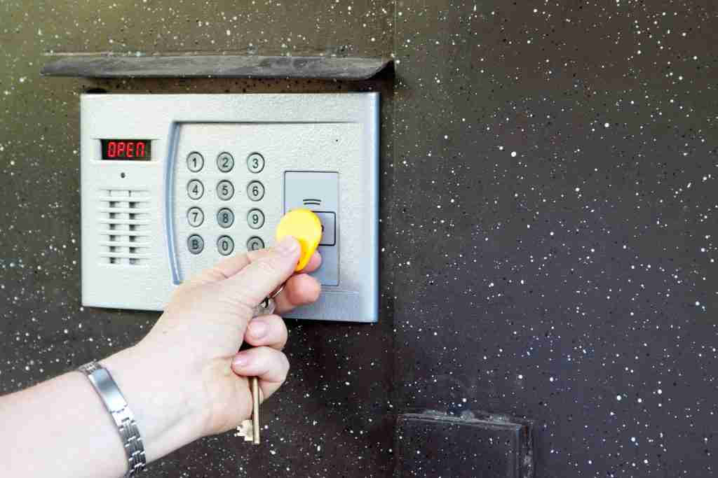 Electronic Access Control system in action picturing a person swiping their fob on the card reader.